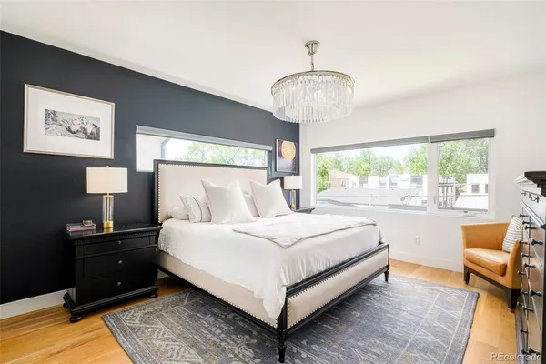 a bedroom with a large bed and a chandelier