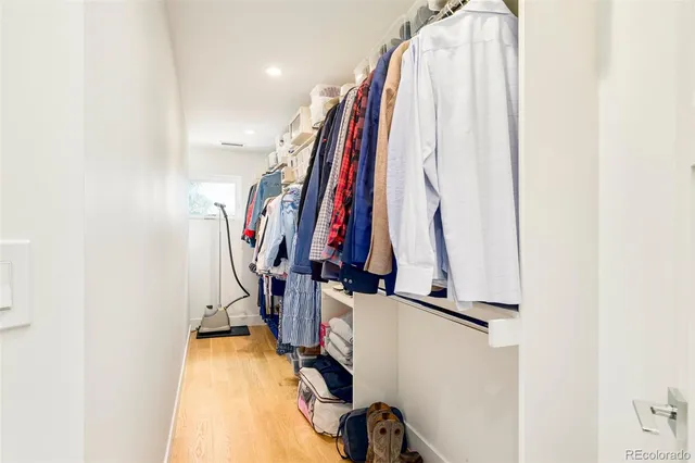 a view of walk in closet with clothes
