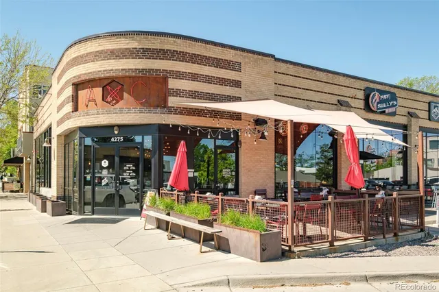a front view of a building with outdoor seating