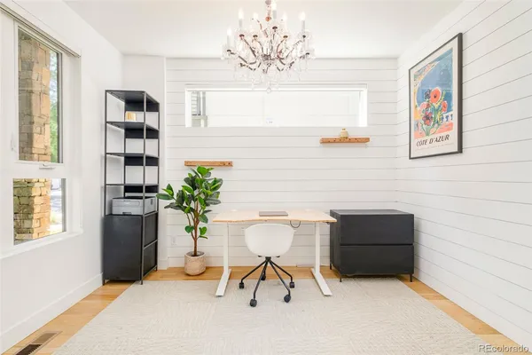 a living room with furniture a chandelier and a window