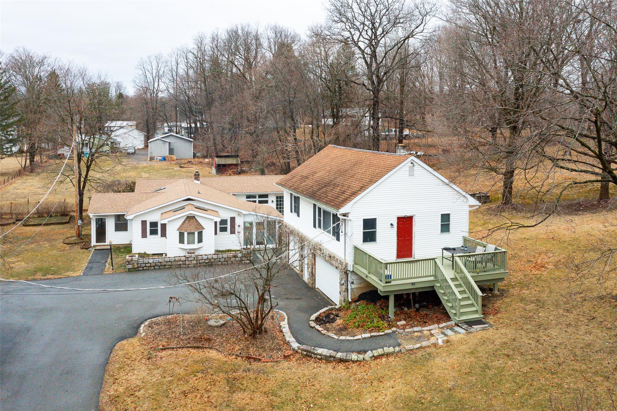 a view of a house with a yard patio and fire pit