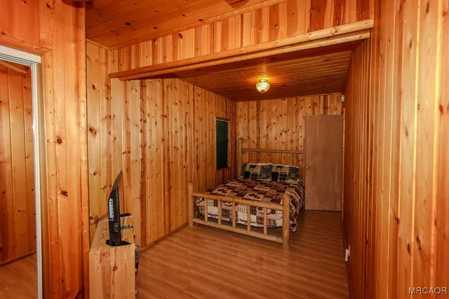 a view of a room with wooden floor and furniture