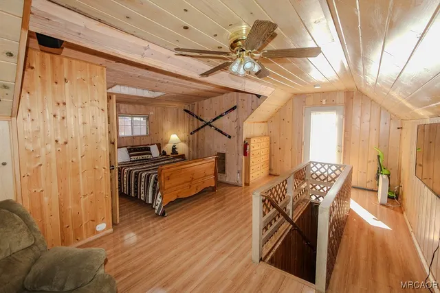 a bedroom with furniture and a wooden floor