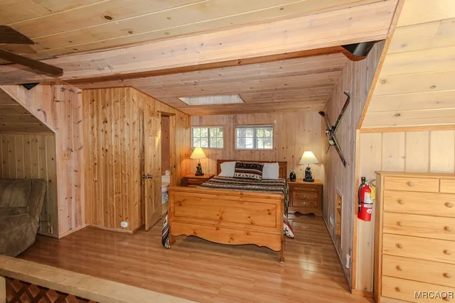 a view of a livingroom with wooden floor and furniture