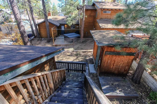 a view of backyard with deck and wooden floor