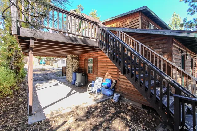 a view of a balcony with two chairs and a potted plant