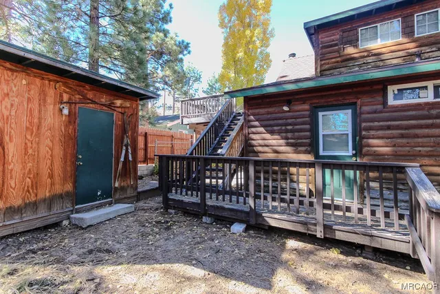 a view of a wooden deck with a yard