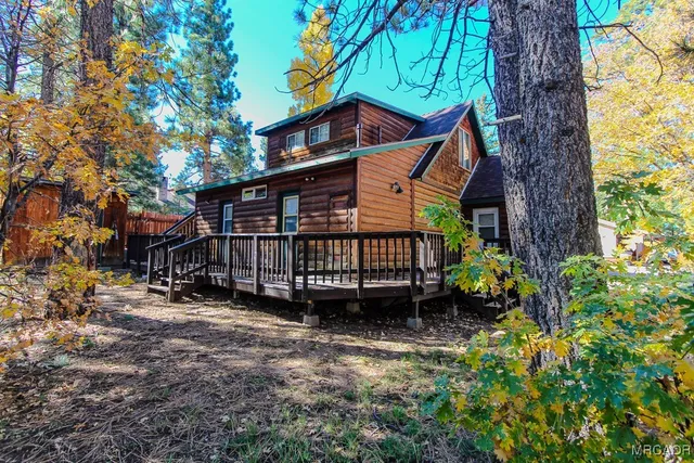 a view of a house with a yard and sitting area