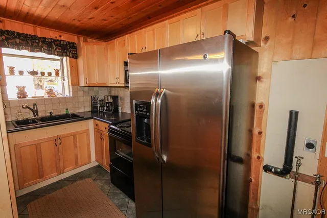 a kitchen with stainless steel appliances a refrigerator and a sink