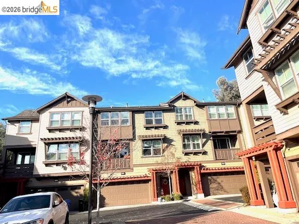 a front view of a residential apartment building with a street