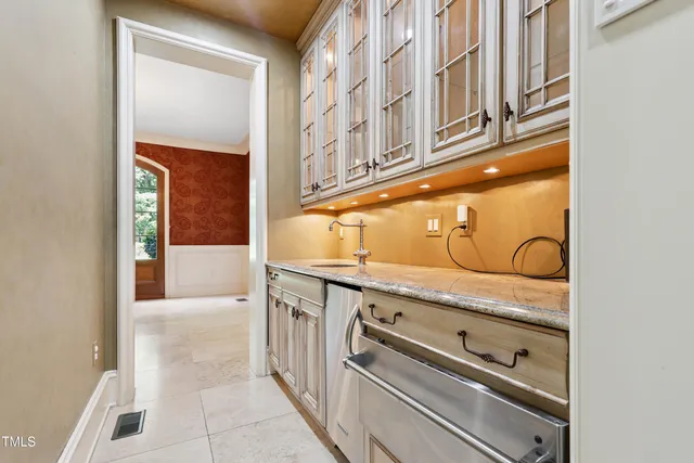 a view of a room with wooden floor and windows