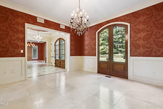 a bathroom with double vanity and a mirror