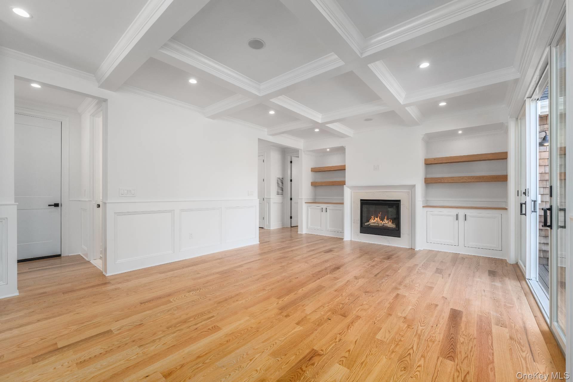 295 Grange Road Southold, NY 11971 - Photo 13 of 50 a view of empty room with wooden floor and fireplace