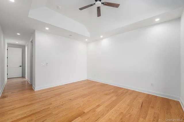 a view of empty room with wooden floor and fireplace