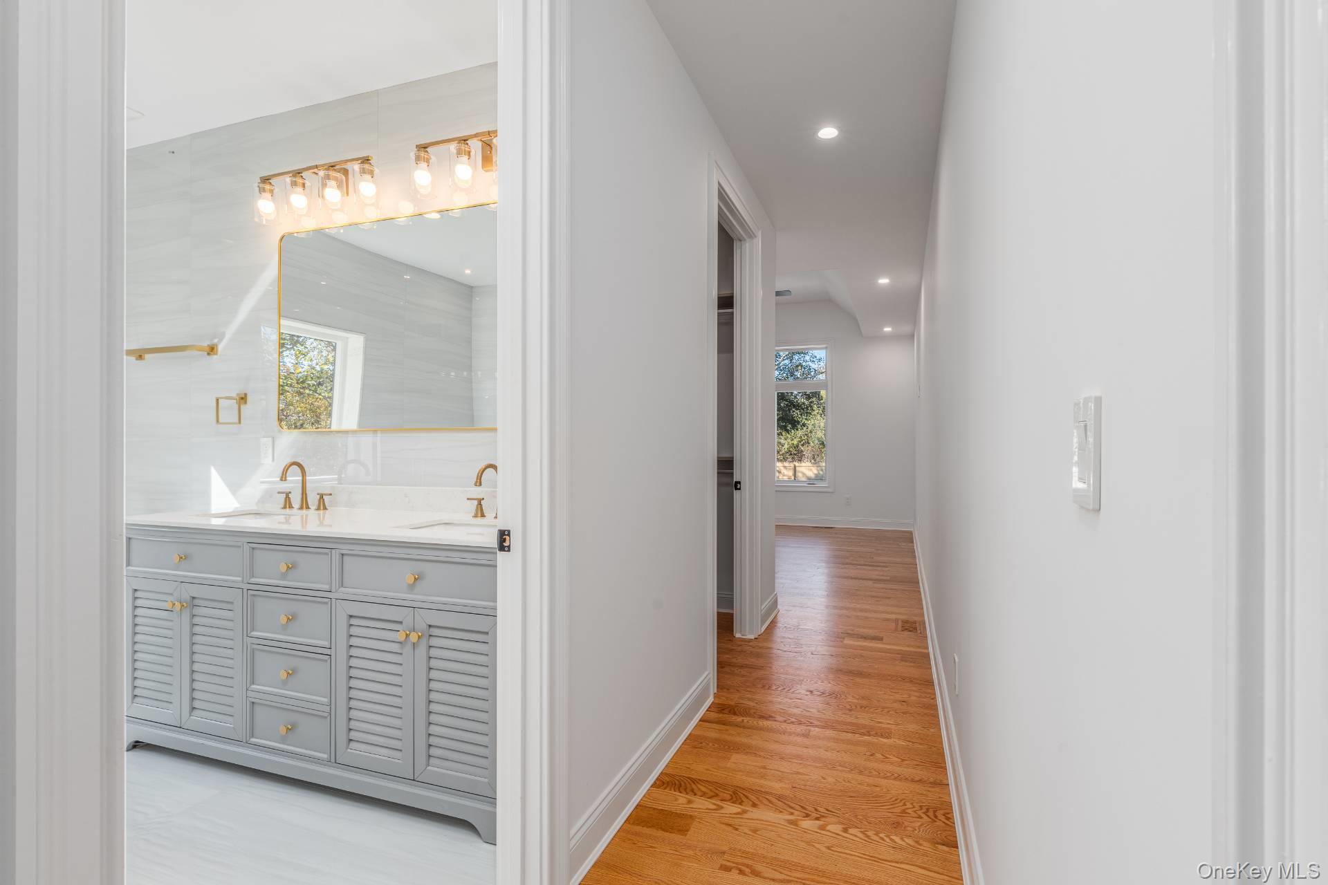 295 Grange Road Southold, NY 11971 - Photo 16 of 50 a hallway with white doors wooden floor and front door