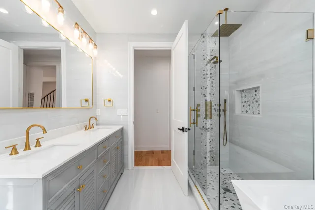 a hallway with white doors wooden floor and front door