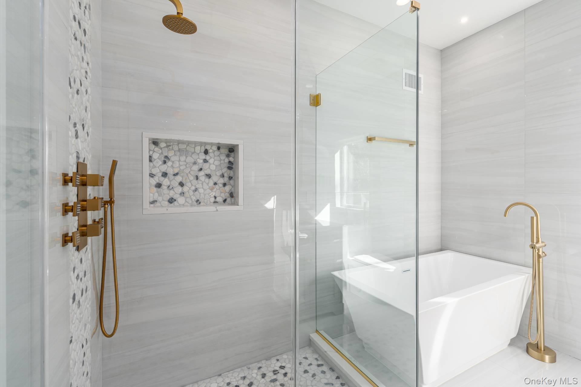 295 Grange Road Southold, NY 11971 - Photo 19 of 50 a bathroom with a bathtub and shower