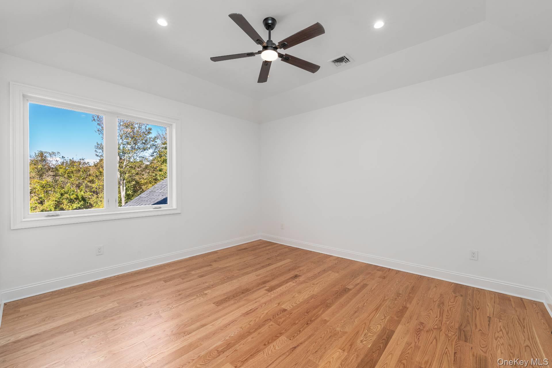 295 Grange Road Southold, NY 11971 - Photo 22 of 50 wooden floor in an empty room with a window