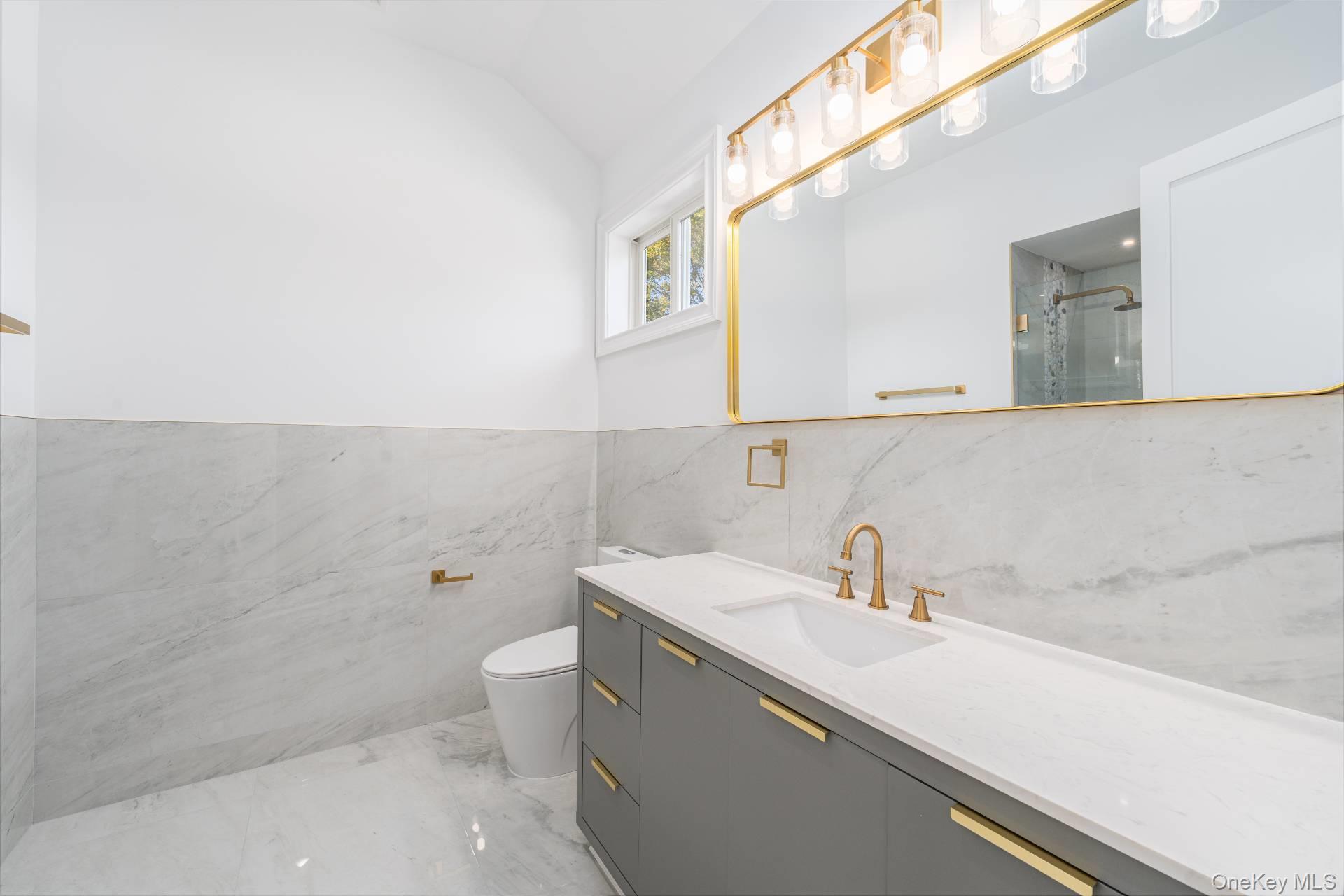 295 Grange Road Southold, NY 11971 - Photo 26 of 50 a bathroom with a sink a toilet and mirror