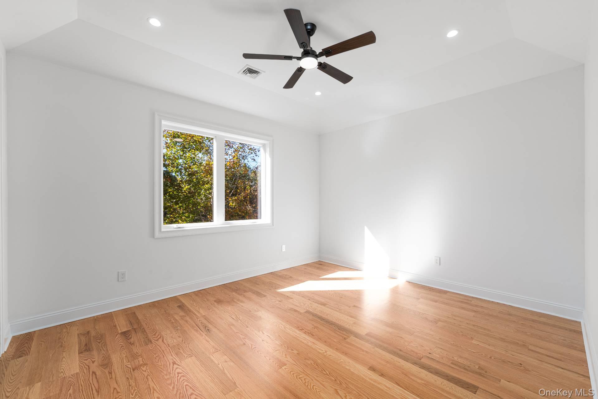 295 Grange Road Southold, NY 11971 - Photo 32 of 50 an empty room with a window and a fan