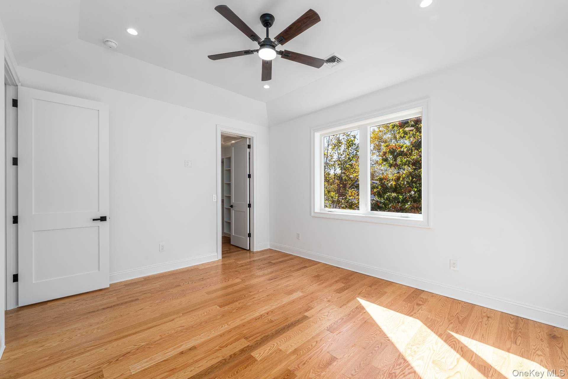 295 Grange Road Southold, NY 11971 - Photo 33 of 50 a view of a big room with wooden floor and a chandelier fan