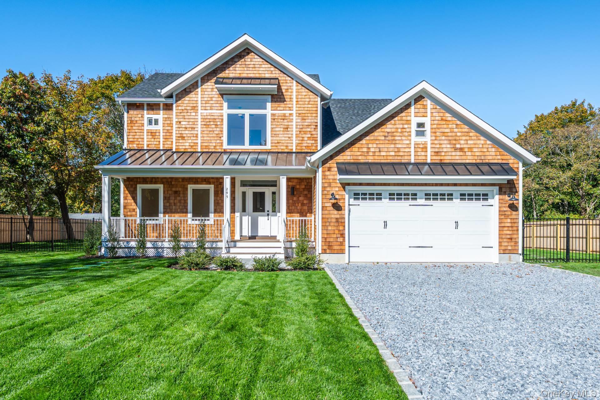 295 Grange Road Southold, NY 11971 - Photo 4 of 50 a front view of a house with a yard and garage