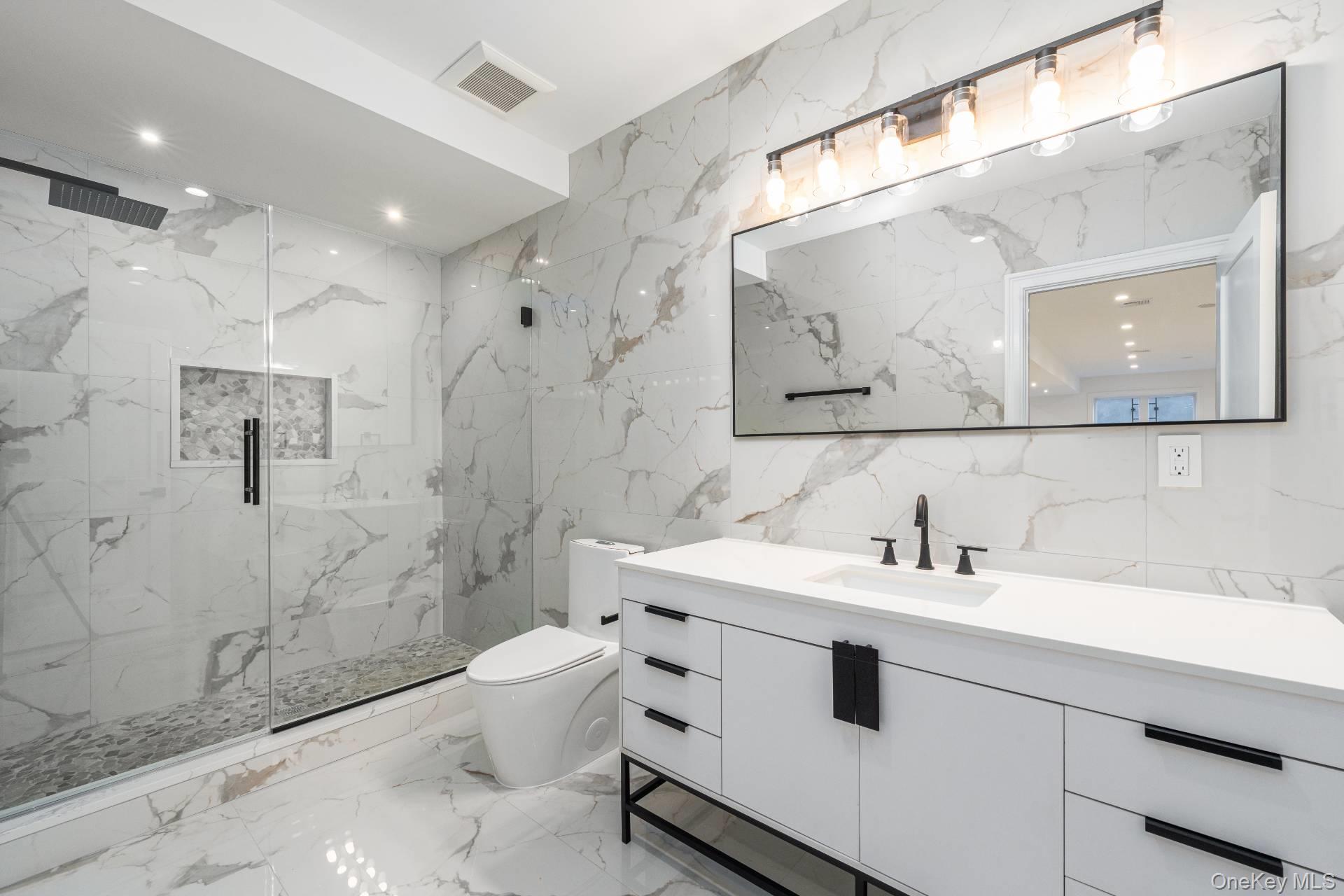 295 Grange Road Southold, NY 11971 - Photo 41 of 50 a bathroom with a sink and a mirror