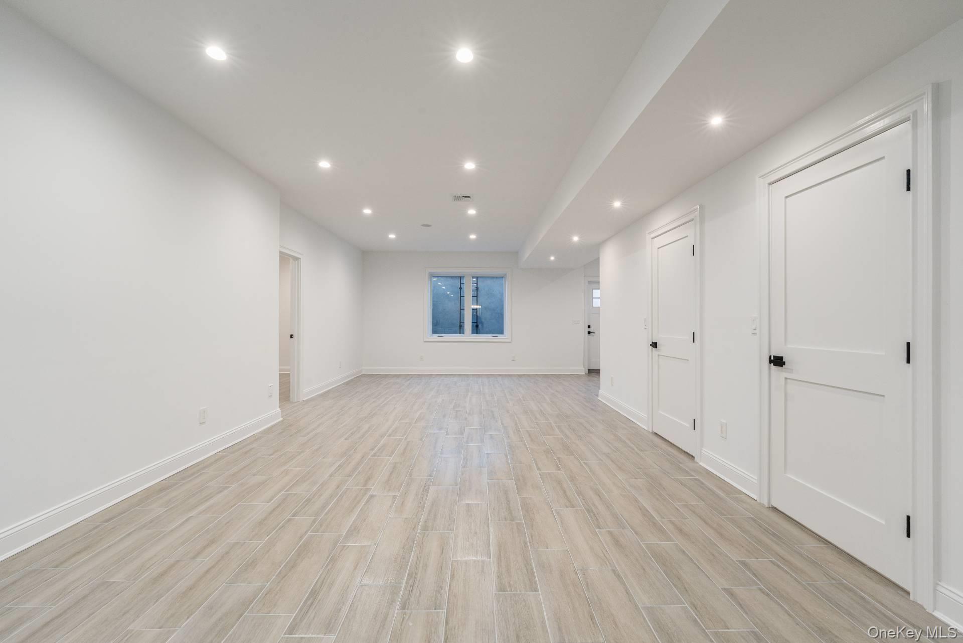 295 Grange Road Southold, NY 11971 - Photo 46 of 50 a view of an empty room with wooden floor