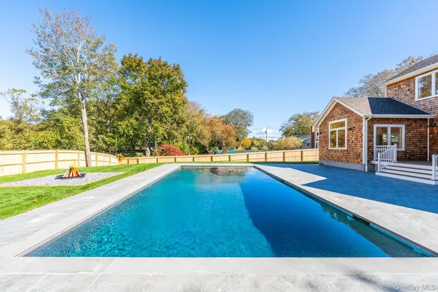 a view of swimming pool with outdoor seating and plants