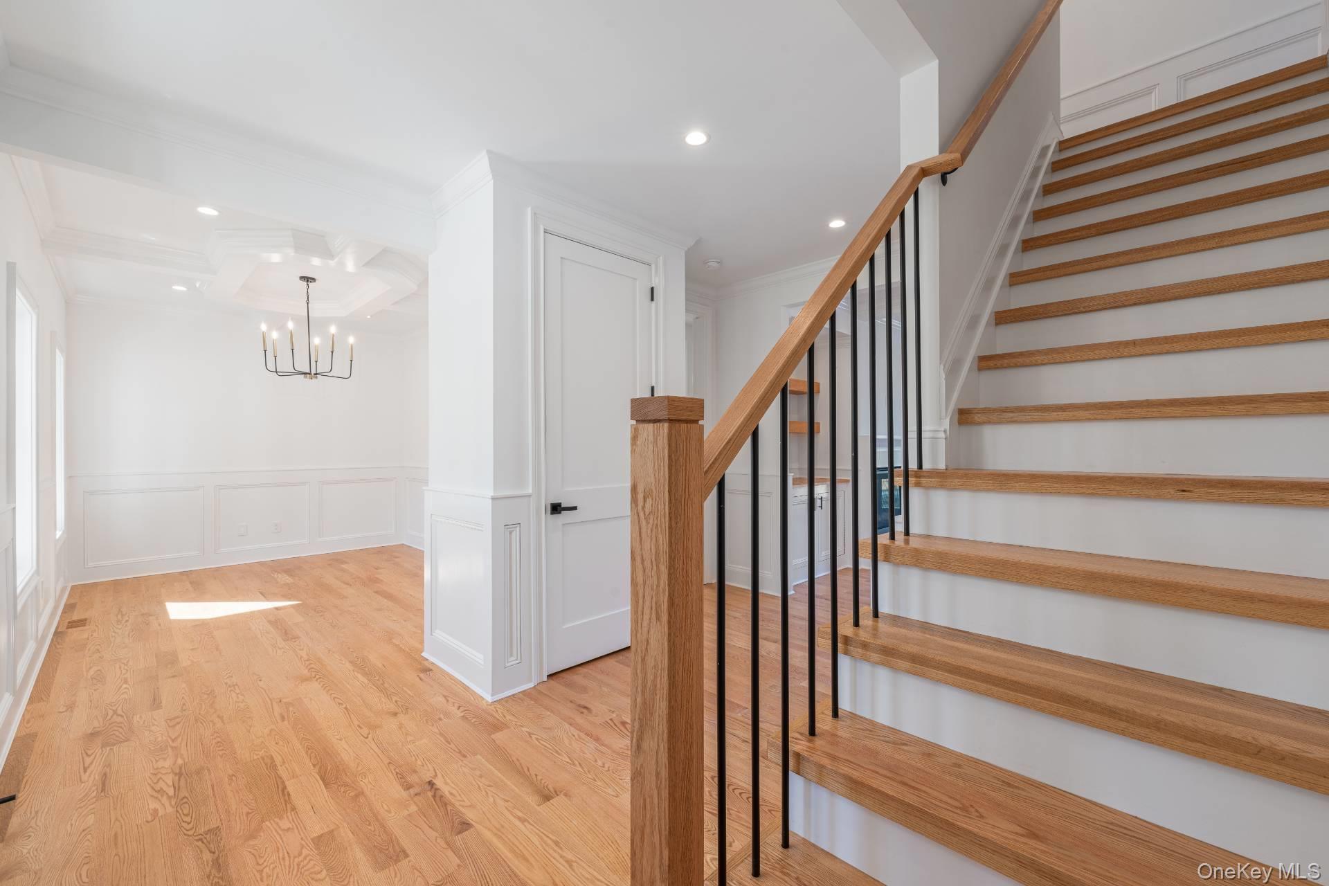 295 Grange Road Southold, NY 11971 - Photo 6 of 50 a view of a hallway with wooden floor and staircase