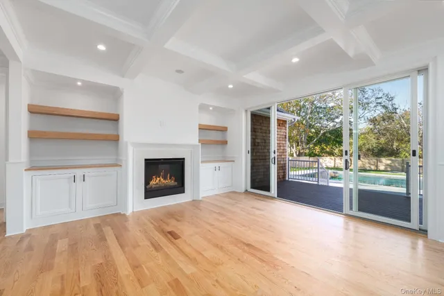 a view of an empty room with a window and a fireplace