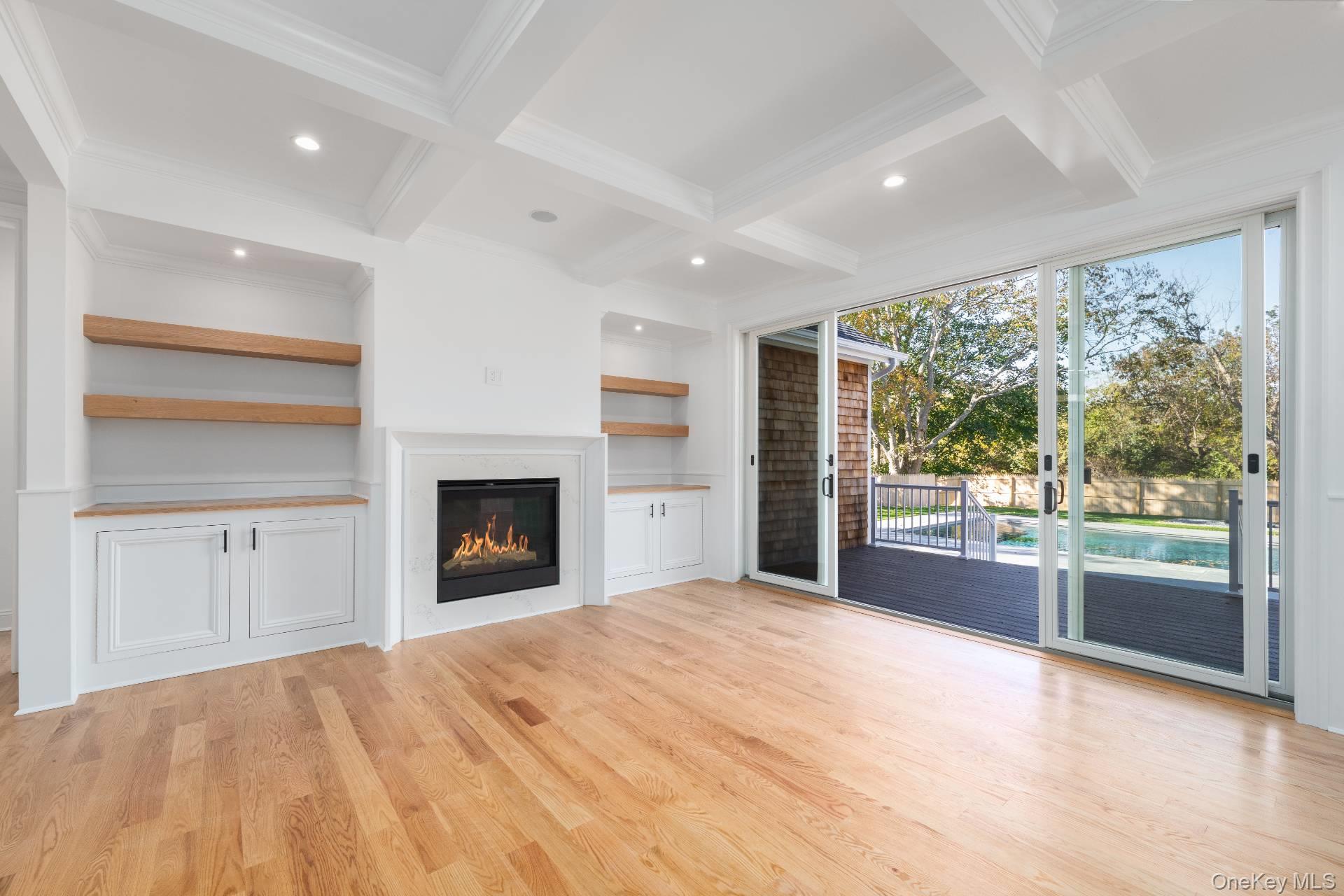 295 Grange Road Southold, NY 11971 - Photo 9 of 50 a view of an empty room with a window and a fireplace