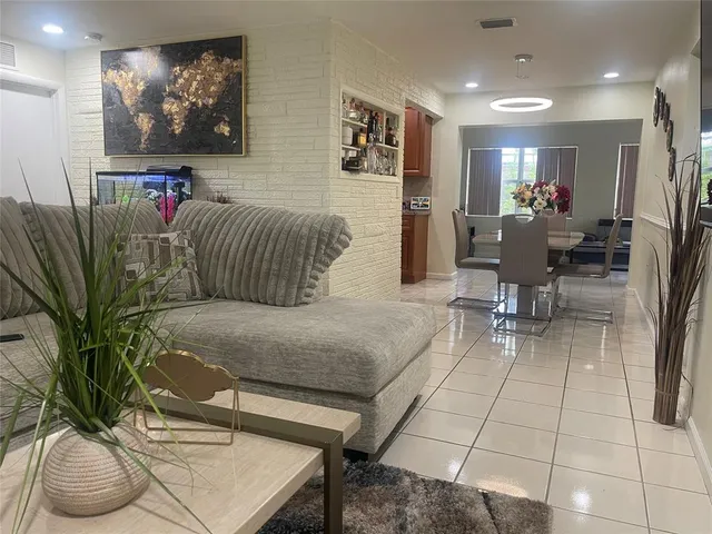 a dining room with furniture and a potted plant