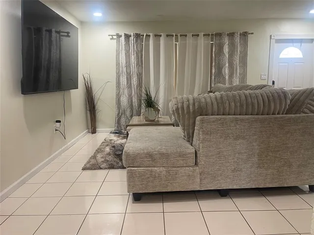 a living room with a couch and a flat screen tv