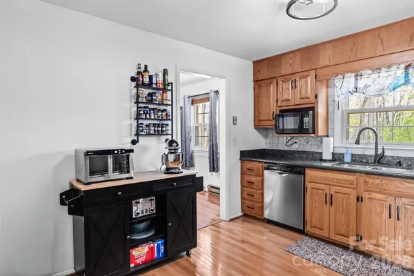 a kitchen with stainless steel appliances a sink stove and cabinets