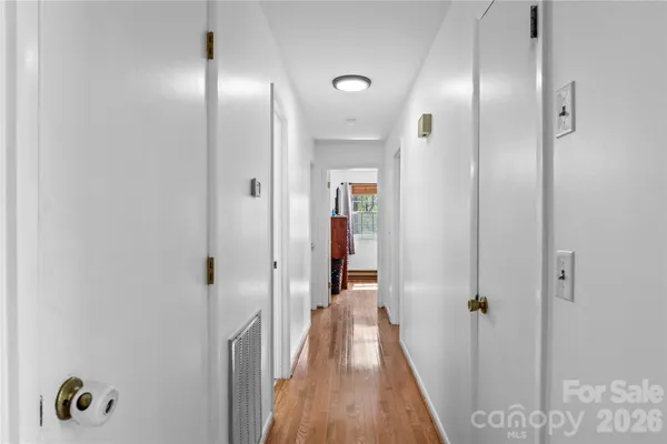 a view of a hallway with wooden floor