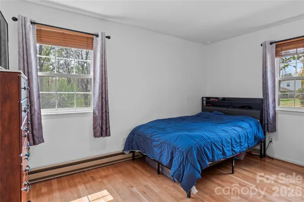 a bedroom with a bed and window