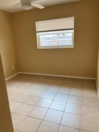 a view of a room with white walls and a window