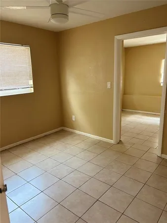 an empty room with a ceiling fan