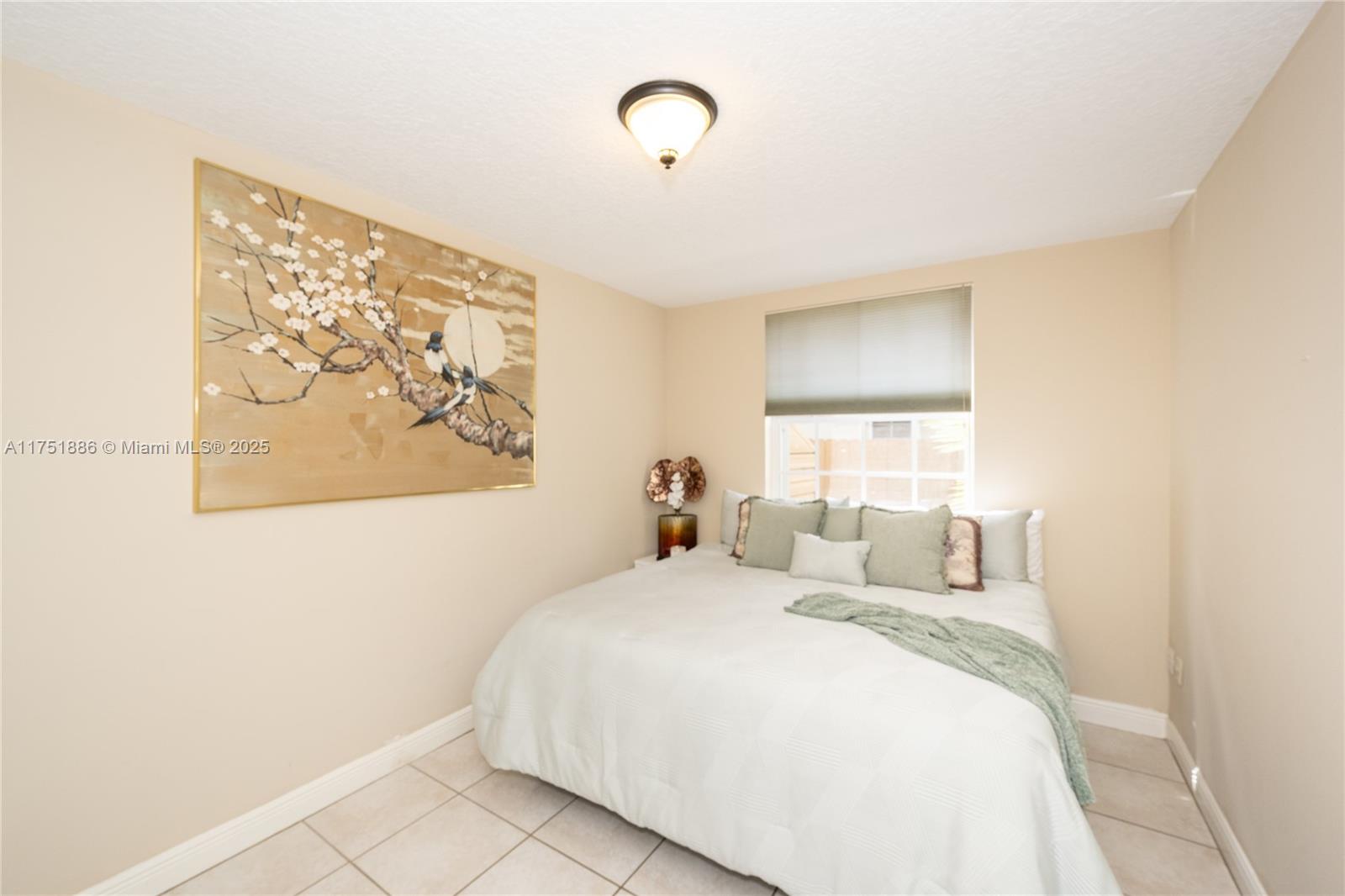 14201 Southwest 34th Street Miami, FL 33175 - Photo 22 of 33 a bedroom with a bed and a painting on the wall