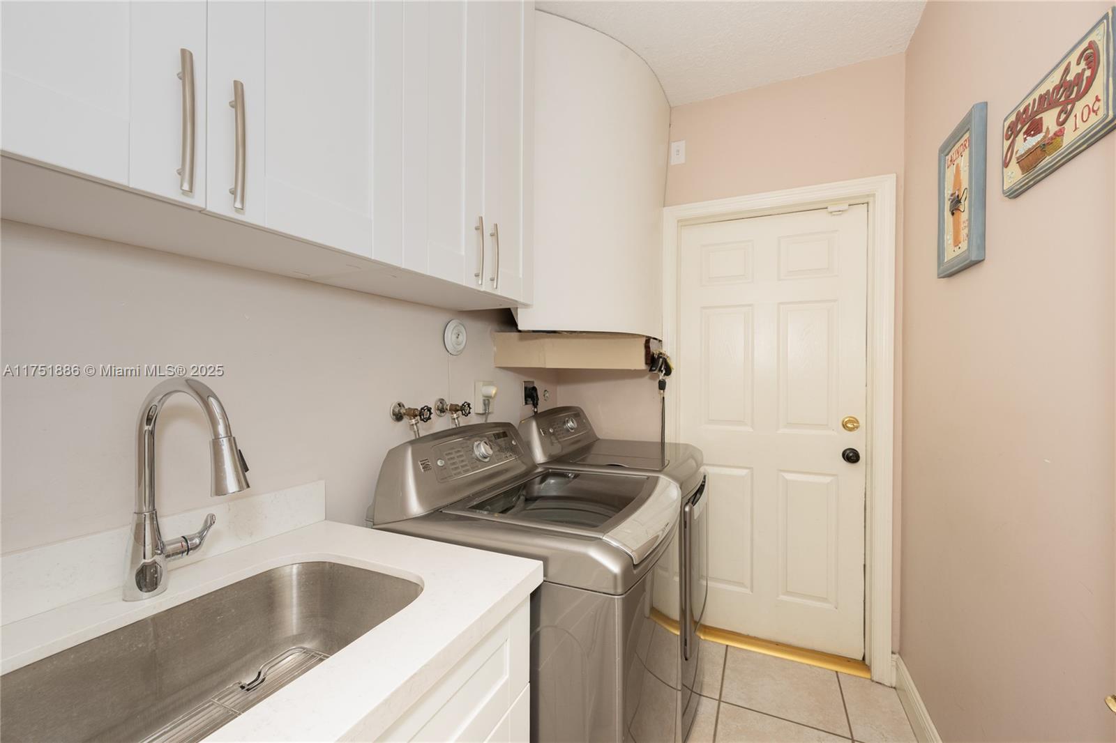 14201 Southwest 34th Street Miami, FL 33175 - Photo 25 of 33 a kitchen with a sink and cabinets