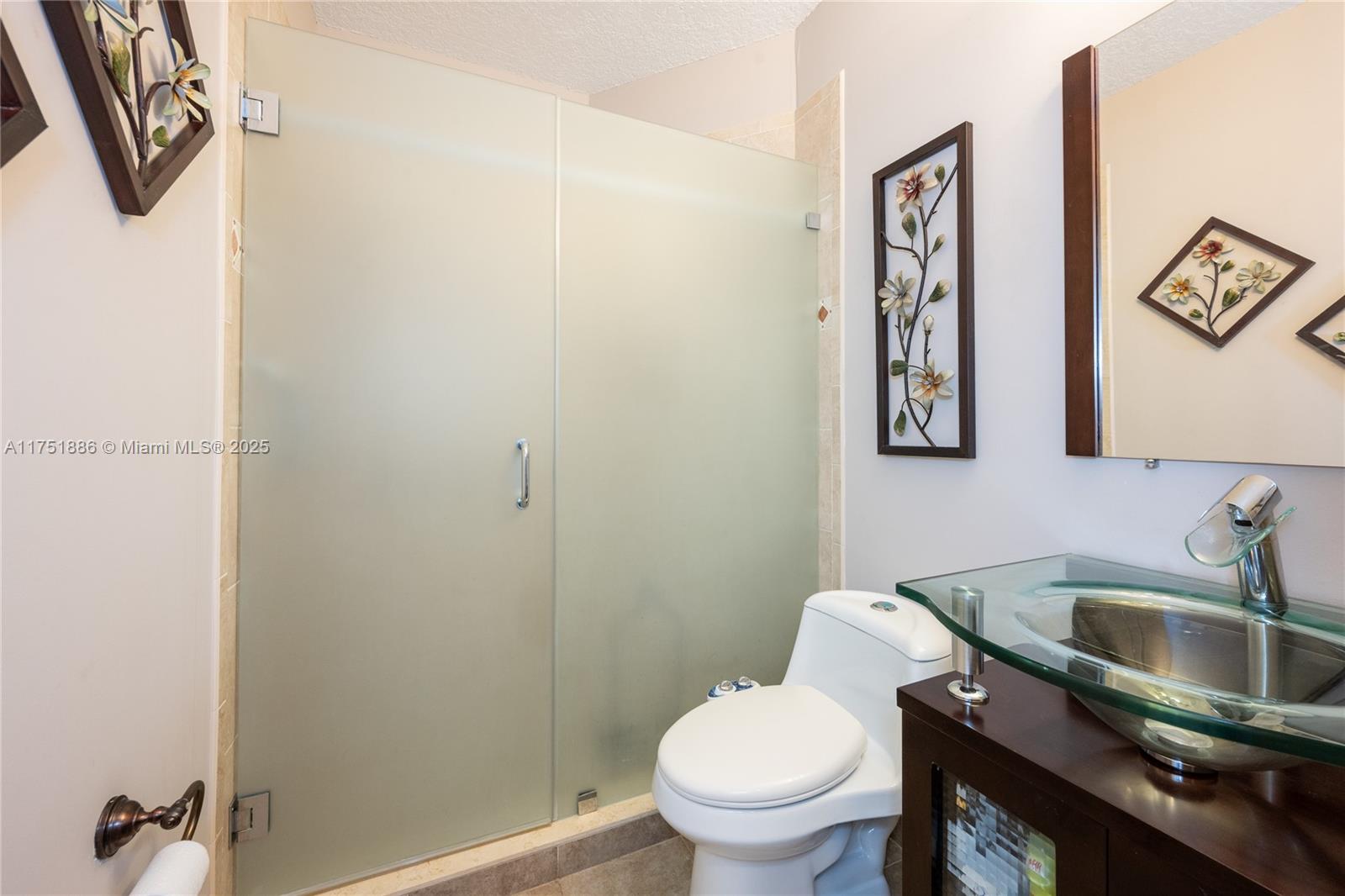14201 Southwest 34th Street Miami, FL 33175 - Photo 26 of 33 a bathroom with a toilet sink and mirror