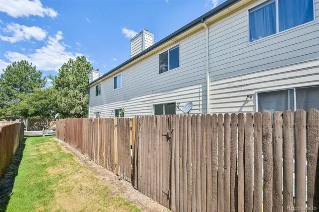 a front view of a house with wooden fence
