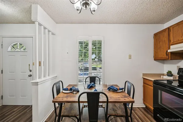 a view of a dining room with furniture wooden floor and chandelier