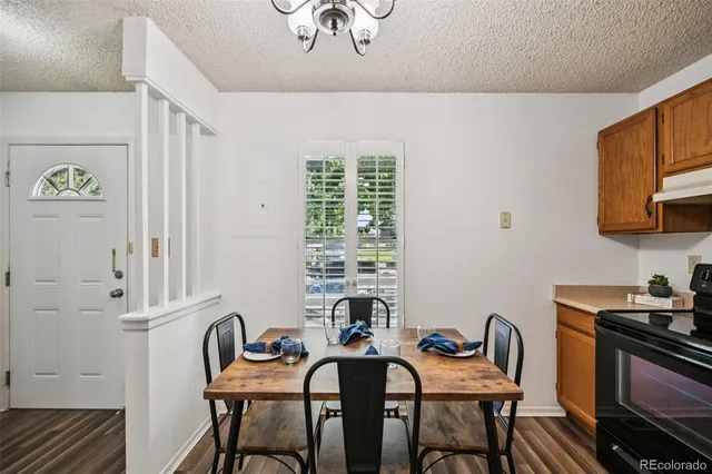 a view of a dining room with furniture wooden floor and chandelier