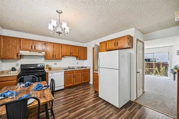 a view of a dining room with furniture kitchen and wooden floor