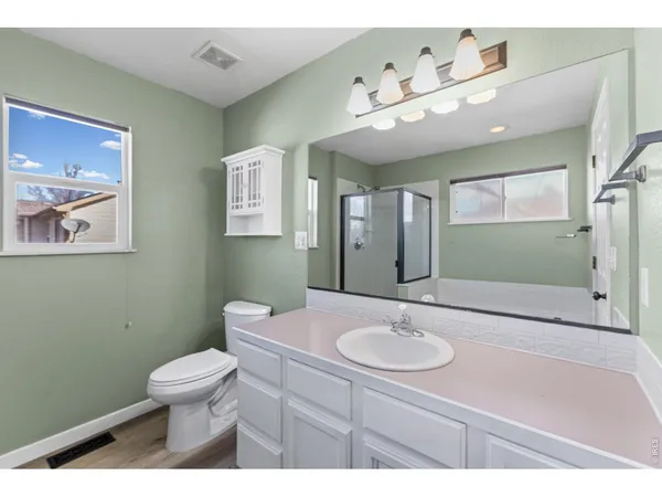 a bathroom with a sink a toilet and mirror