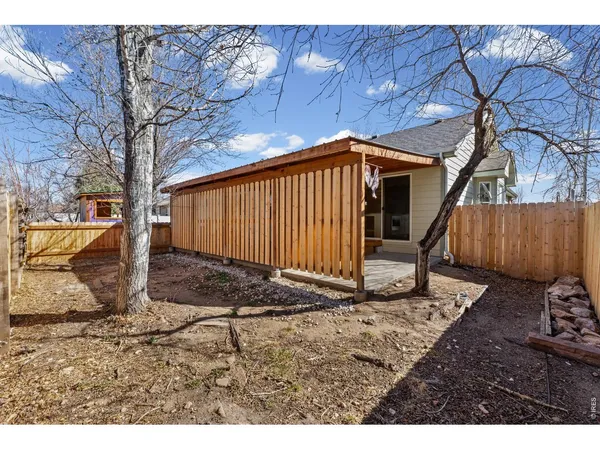 a view of a backyard with wooden fence