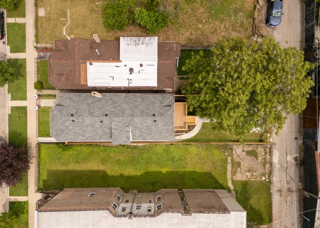 an aerial view of a house with a yard