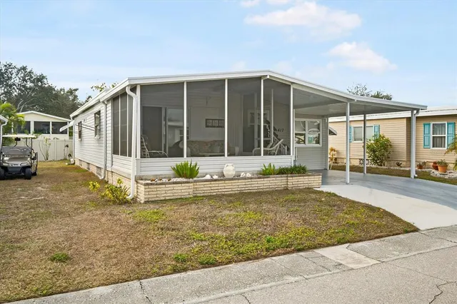 a view of a house with backyard and porch